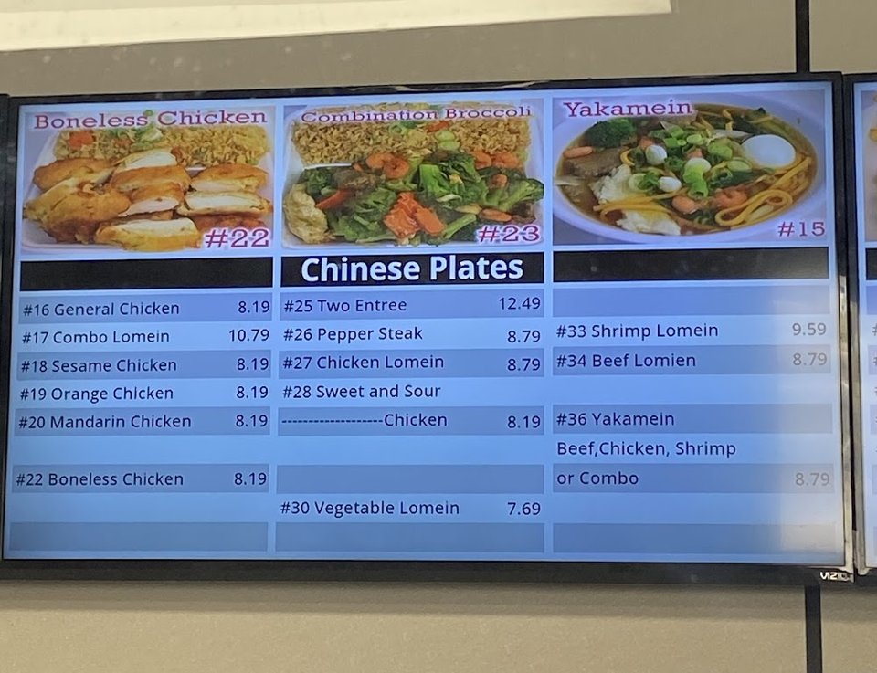 Menu board with seafood platters and wraps.