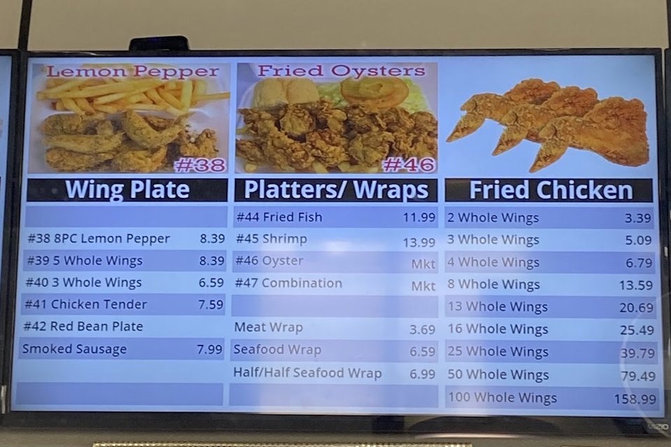 Printed menu showing salads and fried chicken.