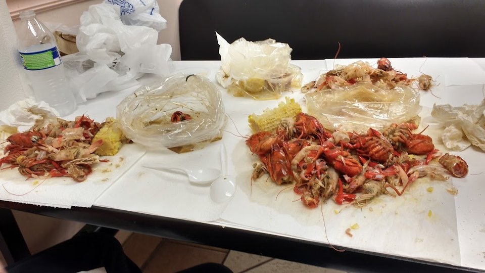 Menu board with seafood platters and wraps.